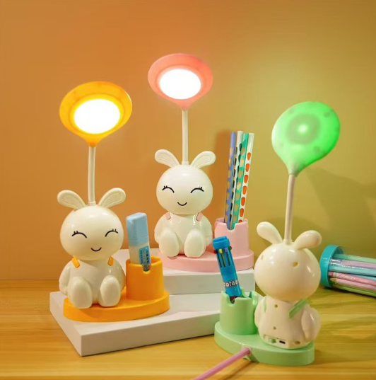 A Desk Lamp, With A Pen Holder, And A Light-Up Toy