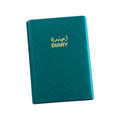 Elite Stationery House teal metallic textured hardcover diary with gold Arabic and English lettering on a desk.