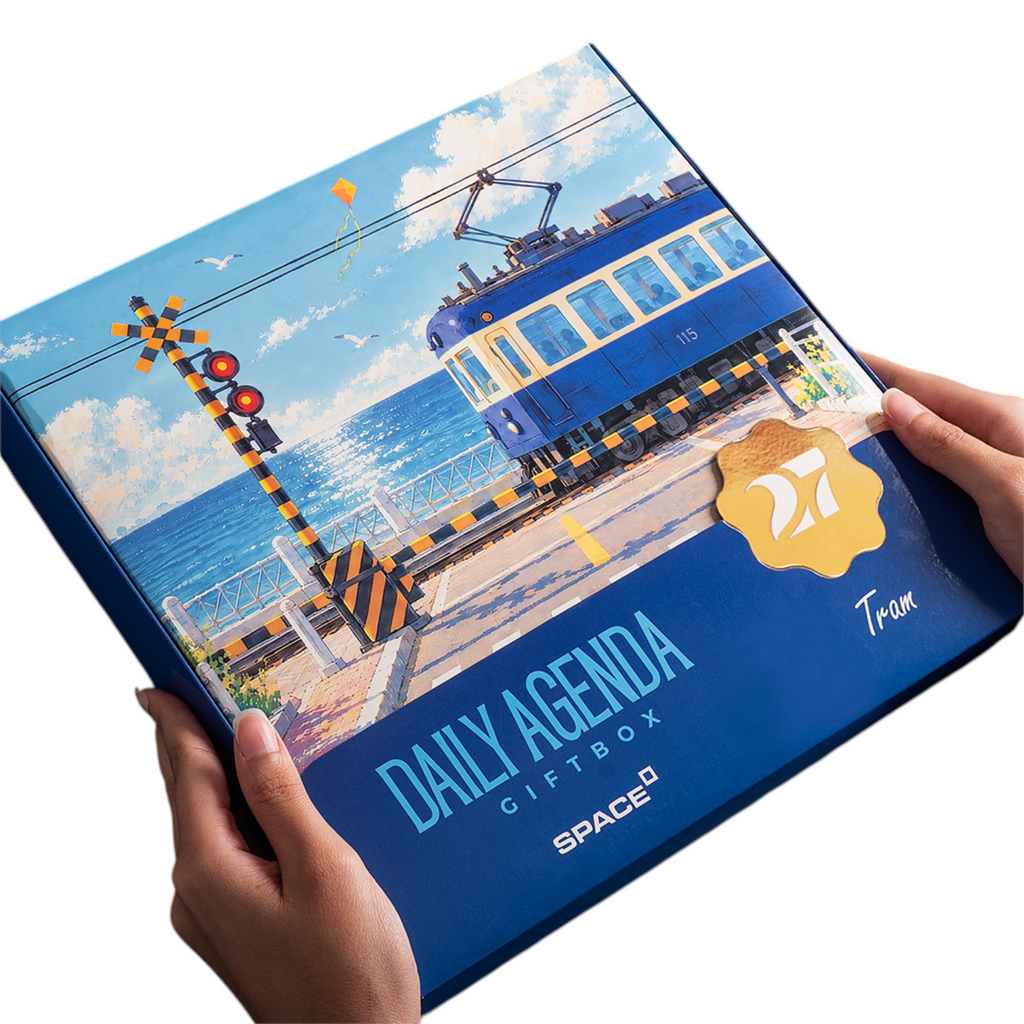 Elite Stationery House 2027 Tram gift box featuring a blue tram illustration, held in hands against a white background.