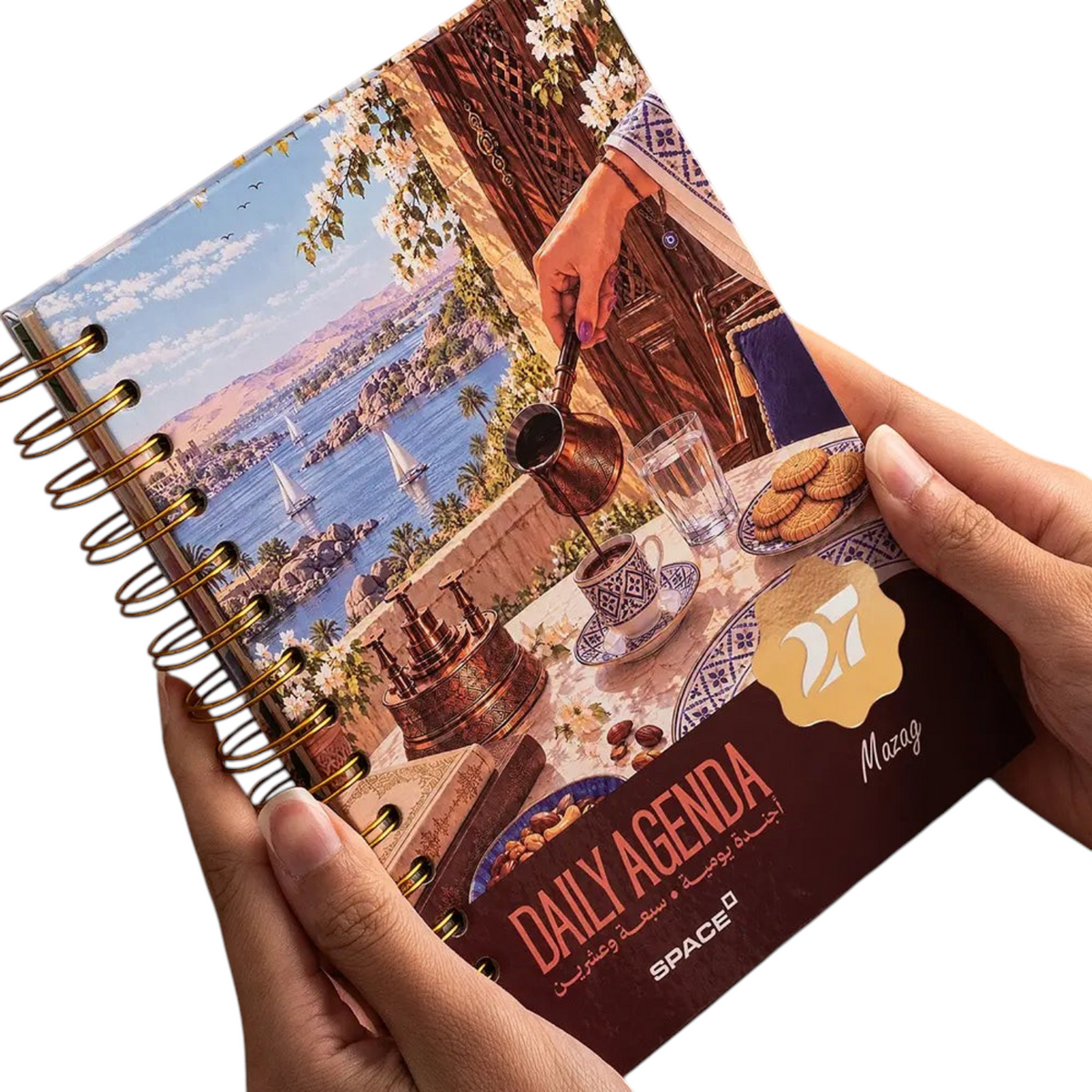 Elite Stationery House 2027 Mazag daily agenda with hard cover, wire binding, and scenic coffee table illustration.