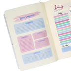 Elite Stationery House A5 cream notebook open to a daily planner page with pastel pink and blue task sections.