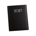 Elite Stationery House 2027 black hardcover diary with silver star design on a wooden desk with a pen.