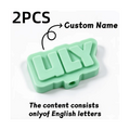 Elite Stationery House 2-piece set of 3D printed custom name pencil toppers in light green plastic.