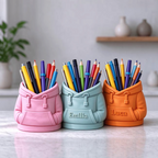 Elite Stationery House personalized 3D printed hooded sweatshirt pen holders in pink, light blue, and orange.