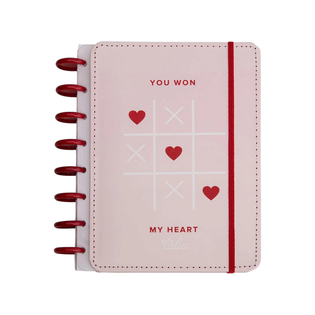 Elite Stationery House Talia A5 hardcover notebook in pale pink with a red tic-tac-toe heart print and disc binding.