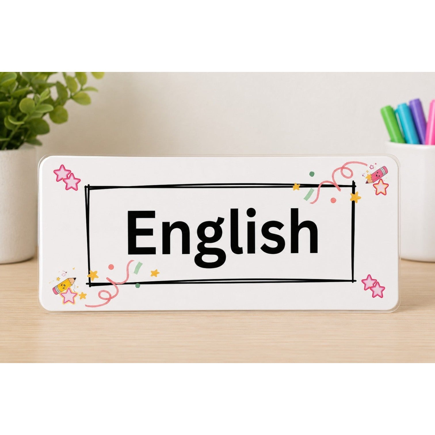 Elite Stationery House English subject label with doodle celebration theme, stars, and confetti on a wooden desk.