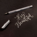 Elite Stationery House Kores silver metallic gel pen with 1mm tip writing Hey Beautiful on a white background
