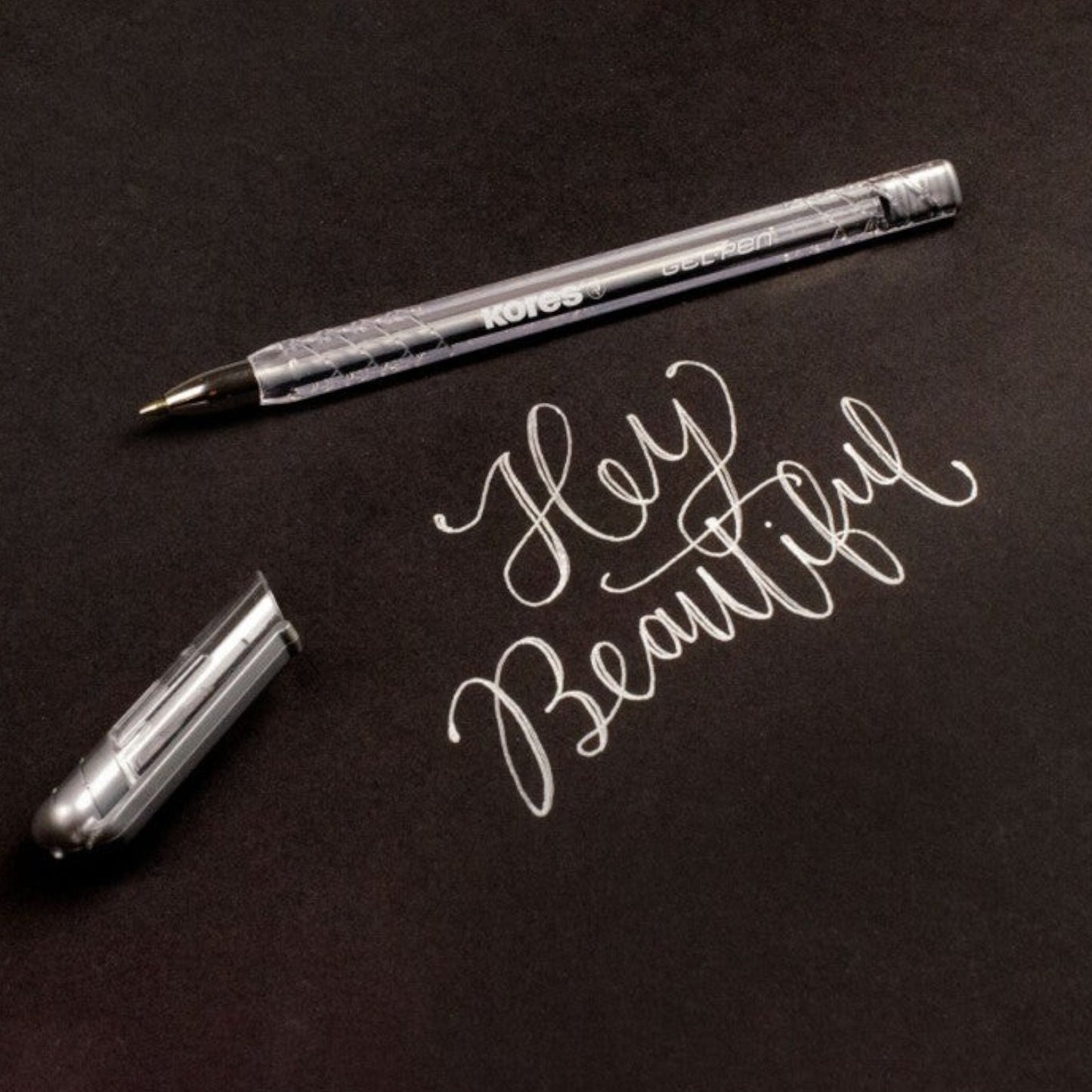 Elite Stationery House Kores silver metallic gel pen with 1mm tip writing Hey Beautiful on a white background
