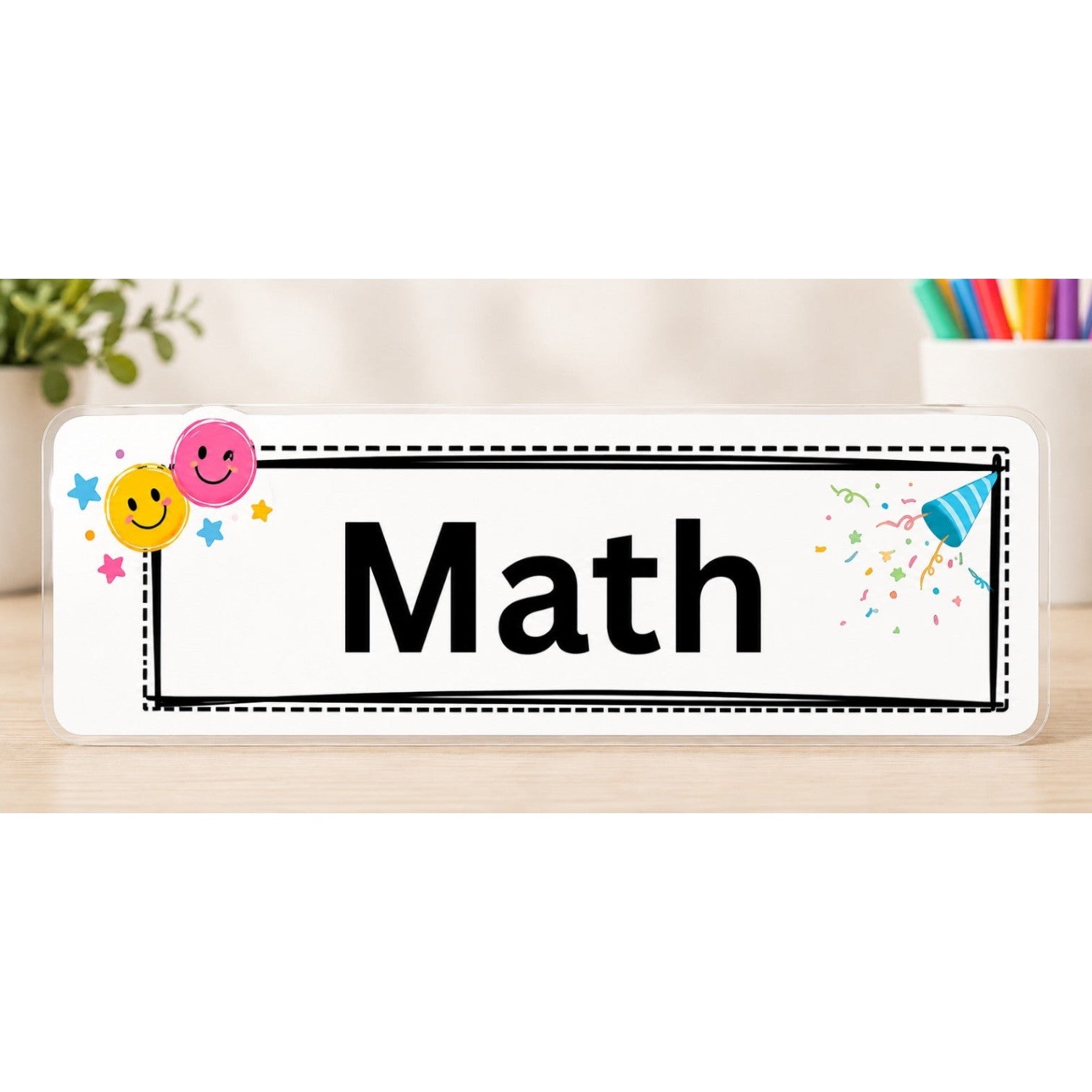 Elite Stationery House laminated Math subject label with smiley face icons and colorful confetti on a wooden desk
