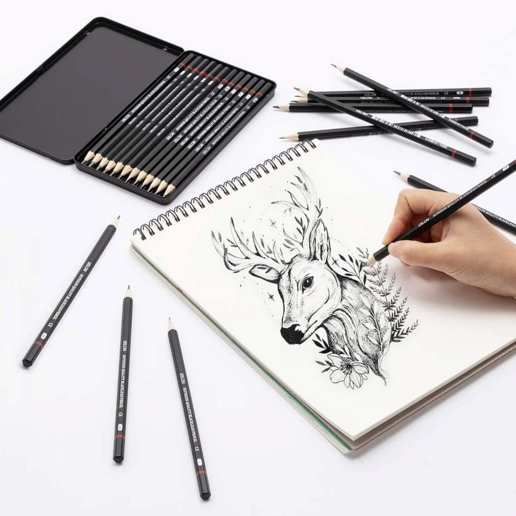 Elite Stationery House 12-piece graphite sketching pencil set in a metal tin with a hand drawing a deer illustration.